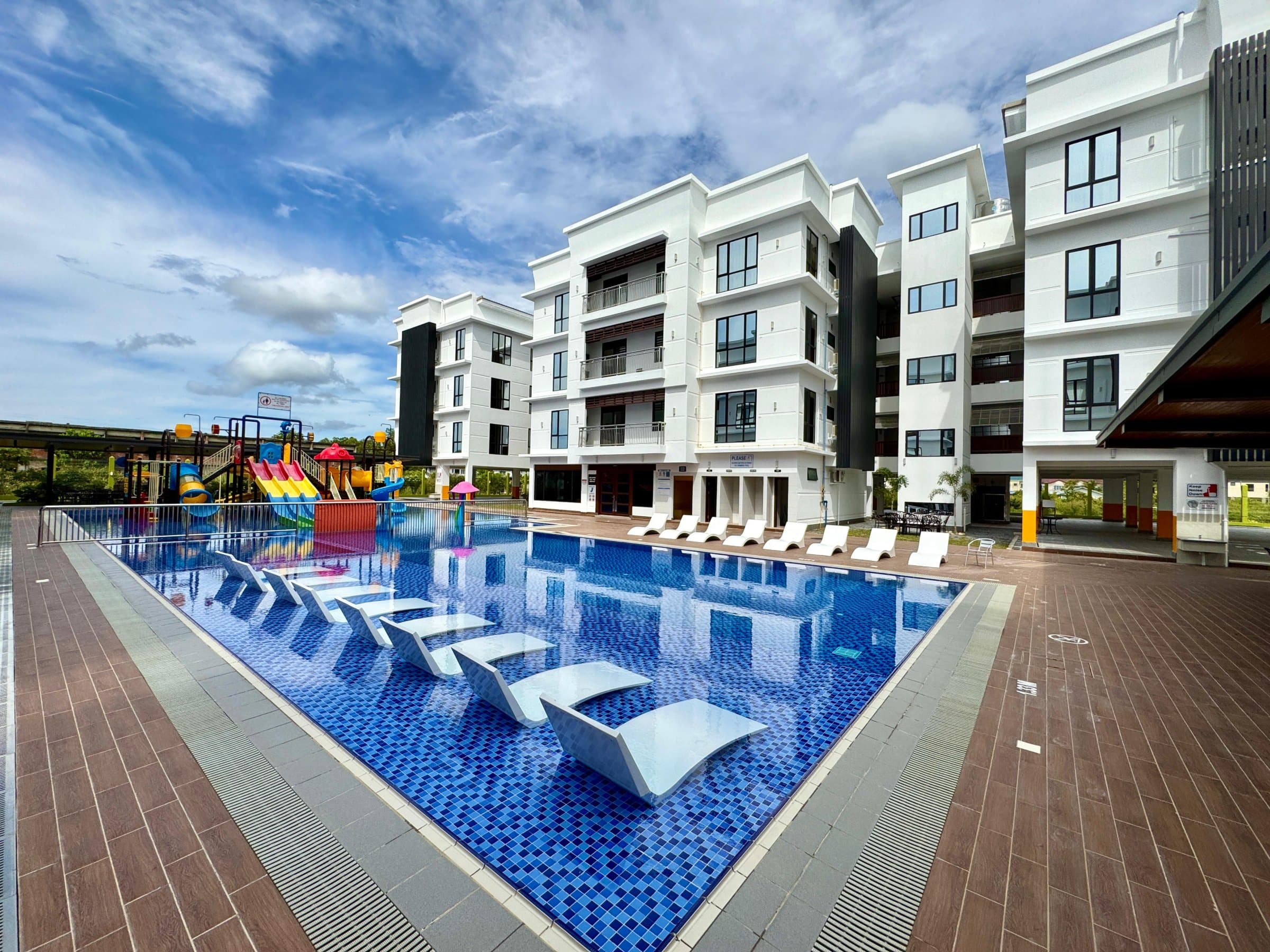 Outdoor pool with sun loungers in the afternoon